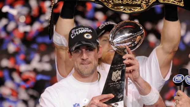 QB Aaron Rodgers hoists the Lombardi Trophy